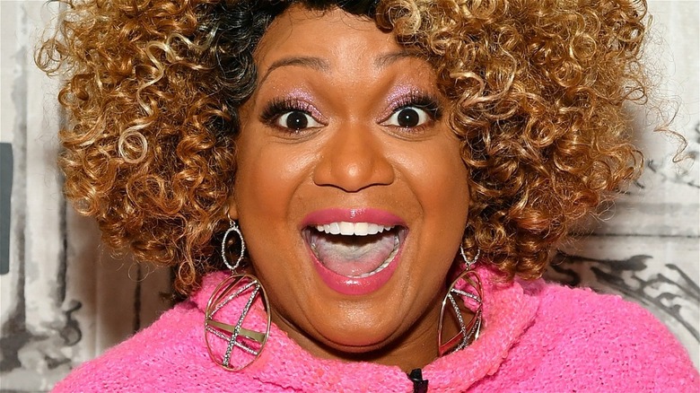 Sunny Anderson smiling in pink