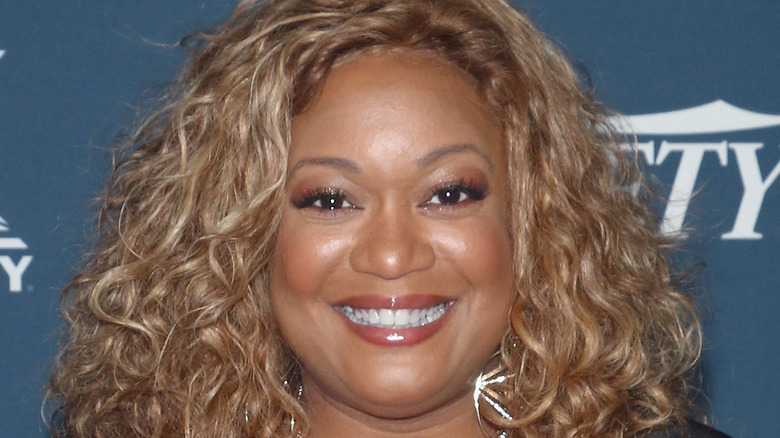 Sunny Anderson smiling and posing