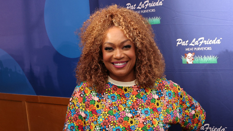 Sunny Anderson smiling at professional panel.