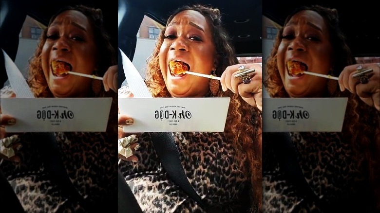 Sunny Anderson biting rice dog