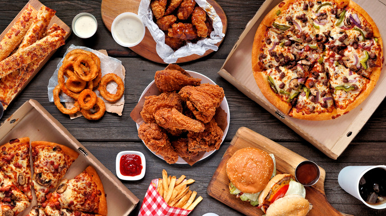 platters of fried chicken and pizza on a table