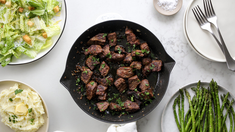 steak pieces in pan