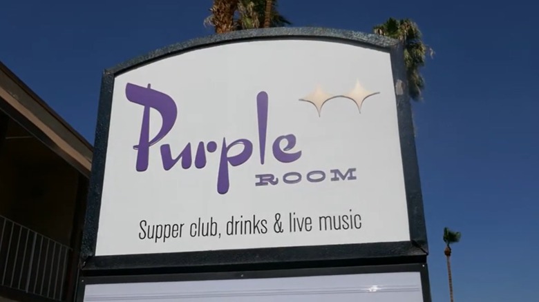 Purple Room sign with palm trees in background