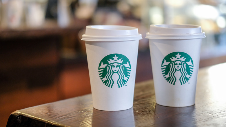 Starbucks to-go coffee cups on table