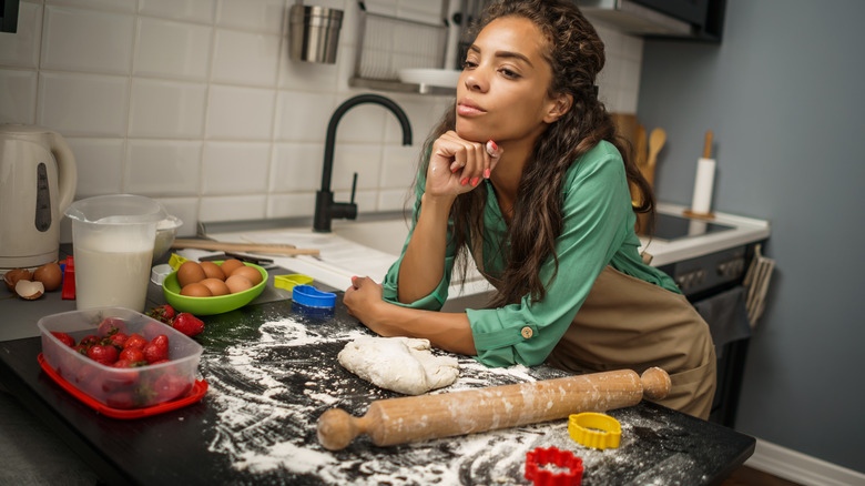 bored woman cooking in kitchen