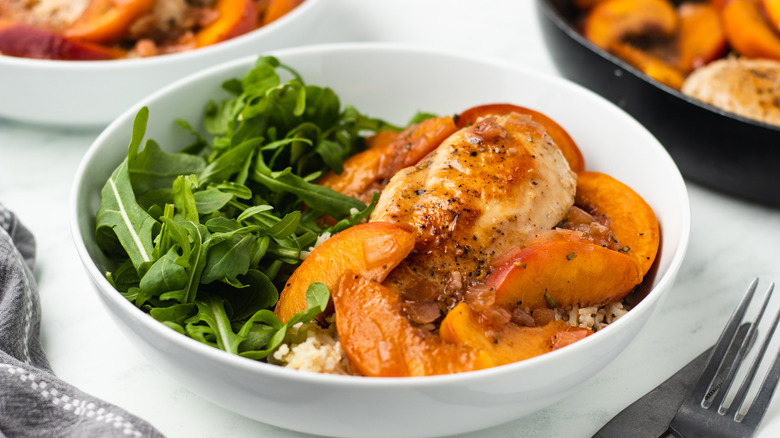 sweet and sour peach chicken in serving bowl
