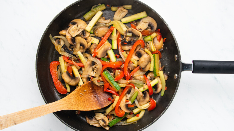 Vegetables frying in pan