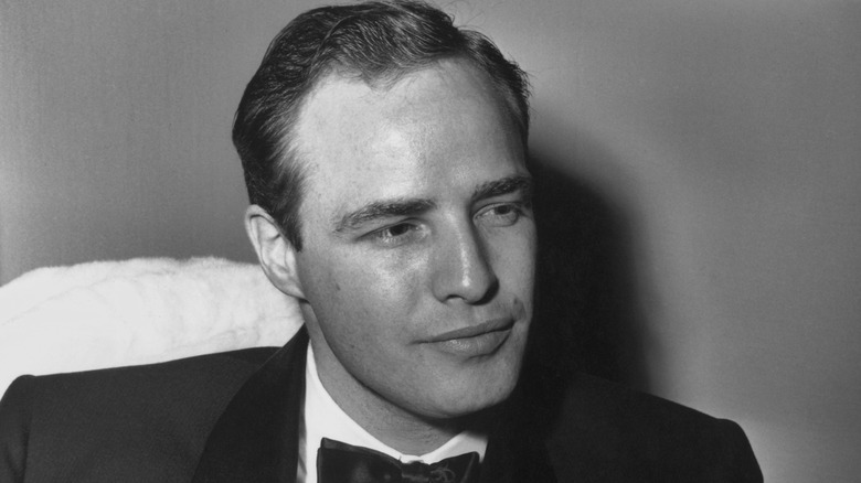 Young Marlon Brando in a tuxedo looking off to the side