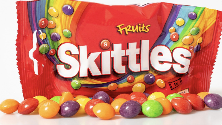 Skittles scattered near bag