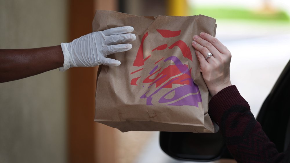 Person receiving Taco Bell order through drive through