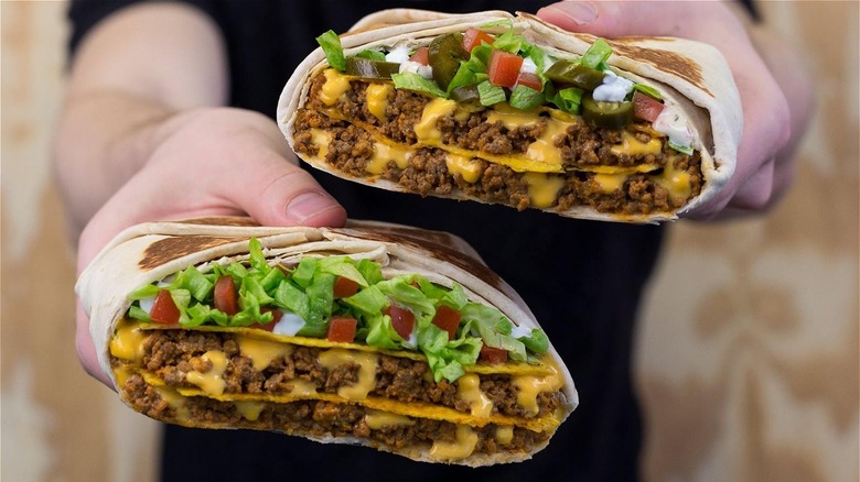 Person holding two beef tacos
