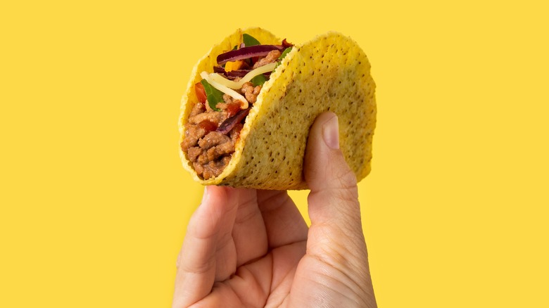 Person holding a taco