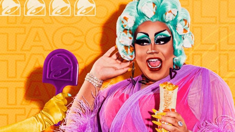 Drag performer in purple top holding a burrito