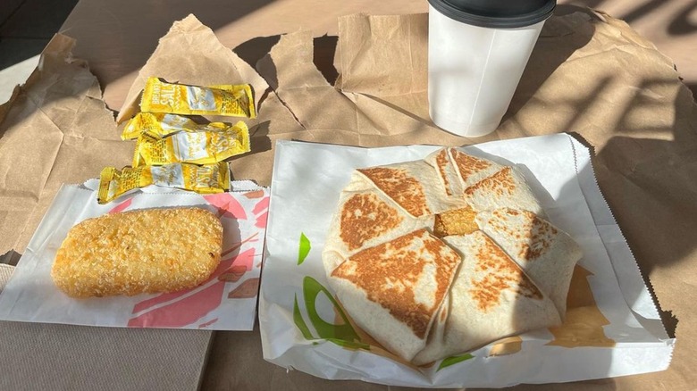 Taco Bell breakfast box crunchwrap, hash brown, and coffee