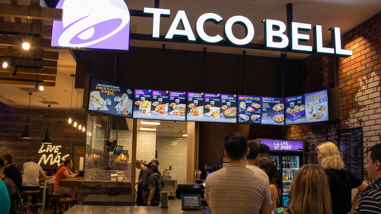 Taco Bell counter service with line of customers