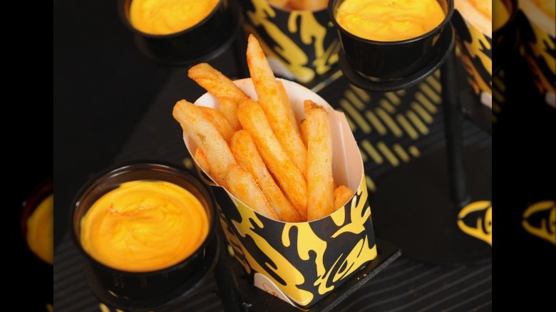 Nacho fries next to cheese sauce