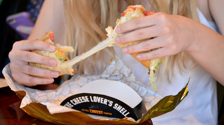 Person stretching cheese from quesalupa