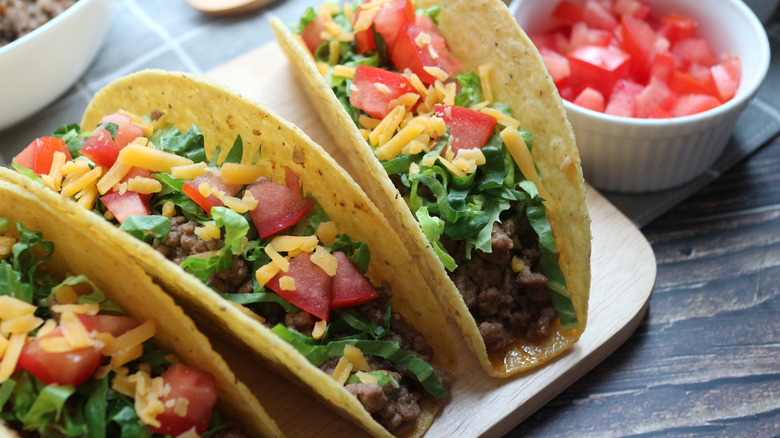 Hardshell tacos on white plate