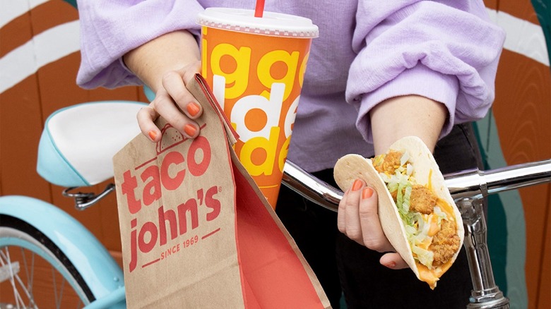 person holding Taco John's