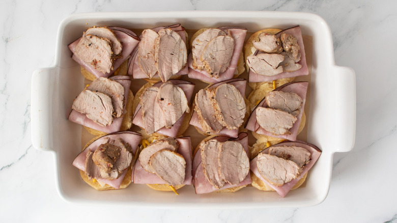 Sliders with ham and pork tenderloin in baking dish