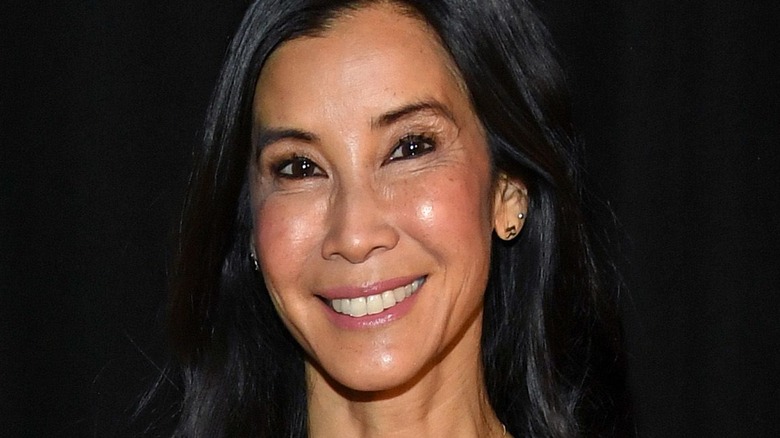 Lisa Ling wearing earrings and smiling