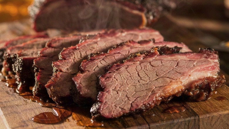 Sliced brisket on a wooden cutting board