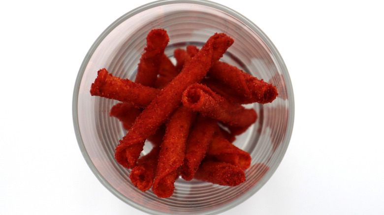 A few Takis rolled chips in a cup