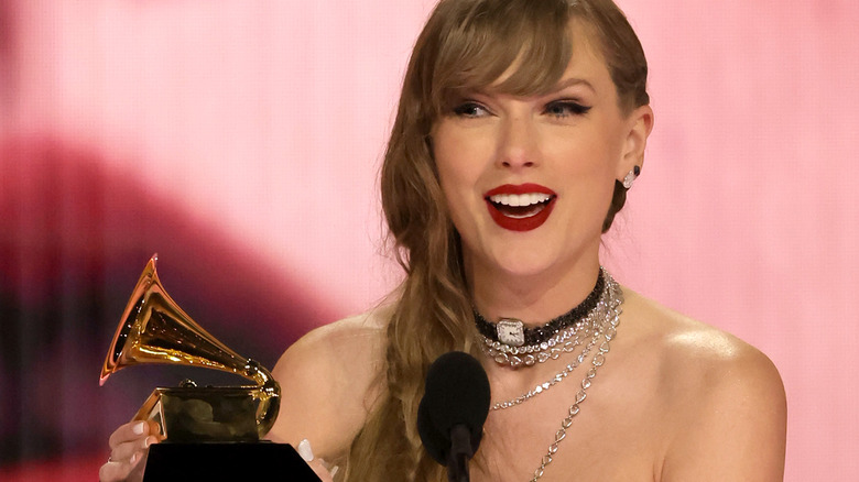 Taylor Swift winning her 4th Album of the Year Grammy in 2024