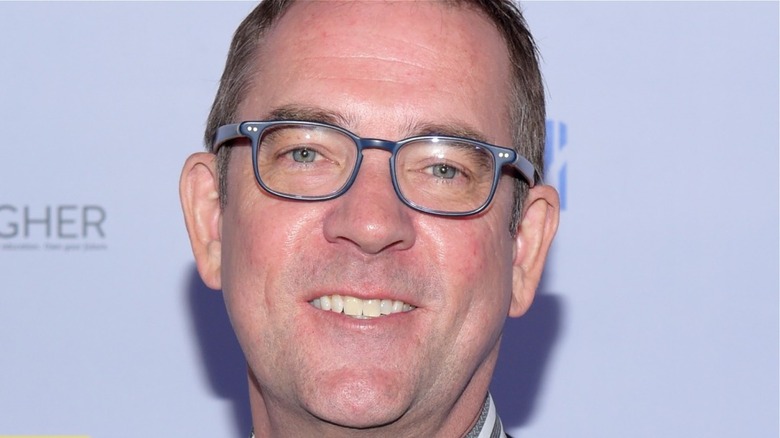 Ted Allen smiles with glasses