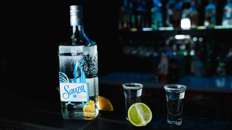 Sauza tequila with shot glasses and citrus