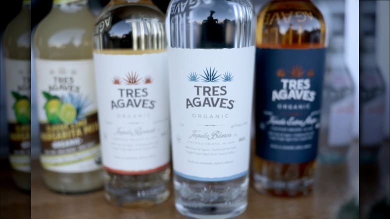Three bottles of different types of Tres Agaves Organic plus a Tres Agaves margarita mix.