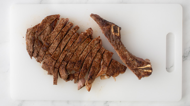 sliced steak on cutting board