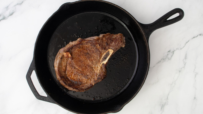 seared ribeye steak in cast iron skillet