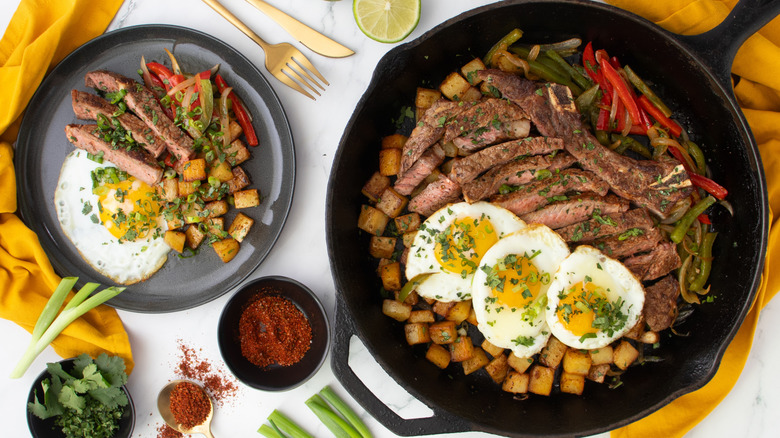 tex-mex steak and eggs on plate and skillet