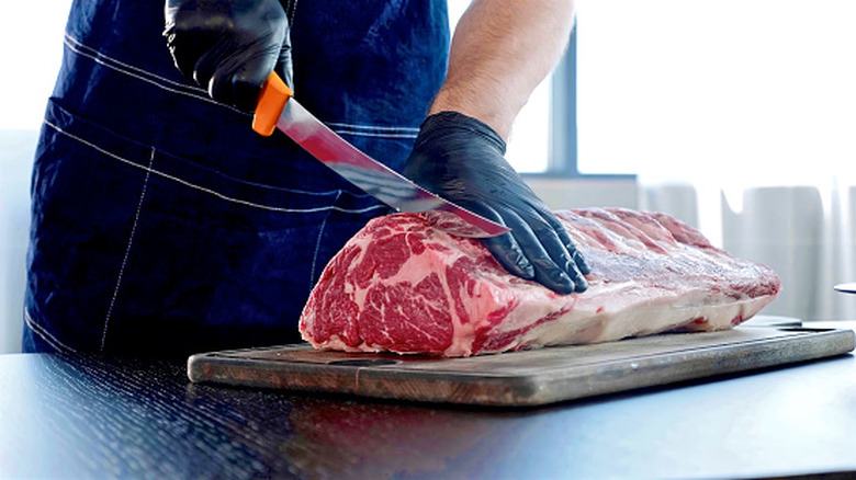 A chef cutting steak.