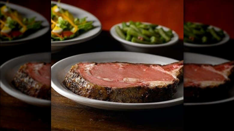 Slice of prime rib on white plate at Texas Roadhouse