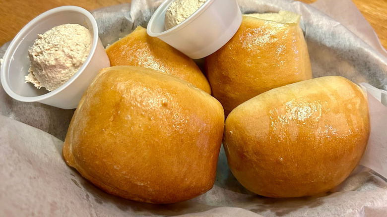 Basket of dinner rolls with honey cinnamon butter at Texas Roadhouse