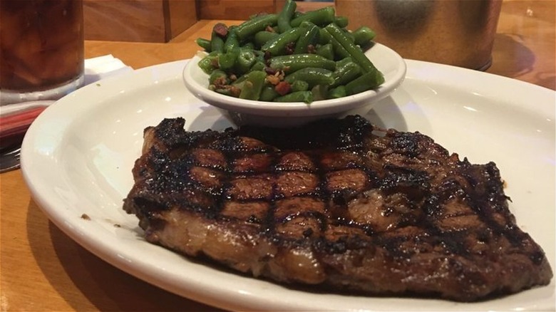 Grilled steak on plate with vegetables at Texas Roadhouse restaurant