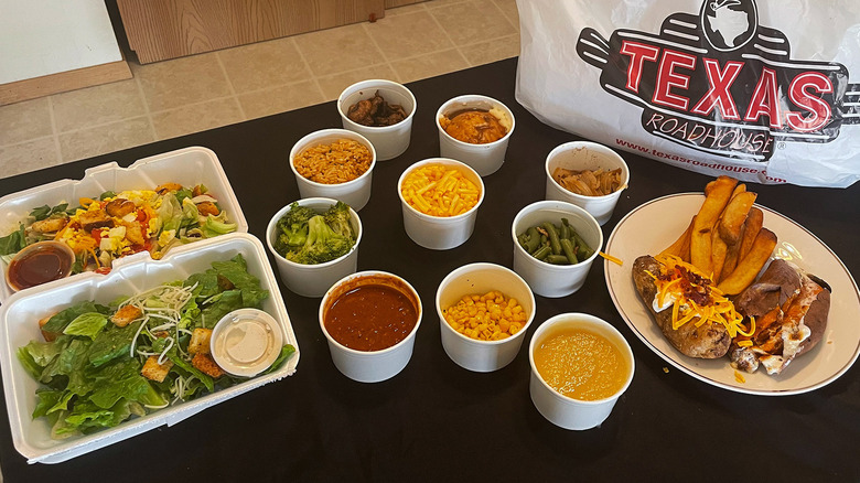 Texas Roadhouse sides and bag on black table