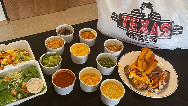 Sides from Texas Roadhouse in to-go containers with a plastic bag on the side