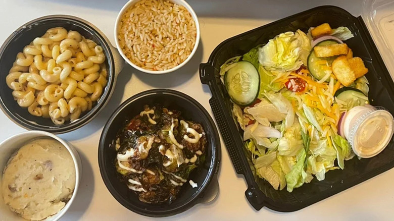 Sde dishes from Outback Steakhouse in to-go containers