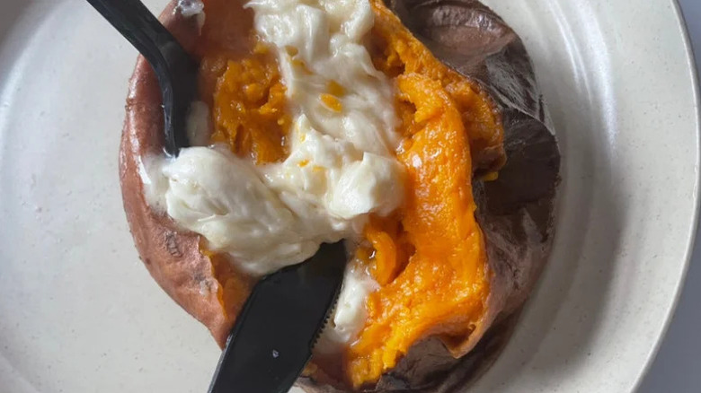 Outback sweet potato with butter on a white plate