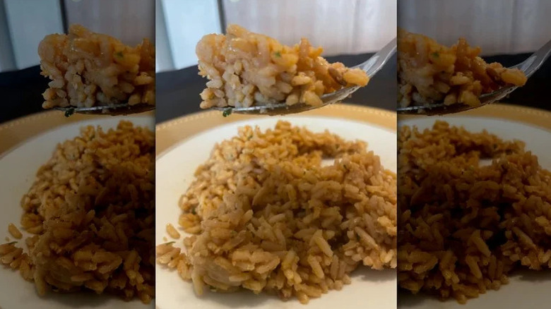 Texas Roadhouse seasoned rice on a white plate and fork