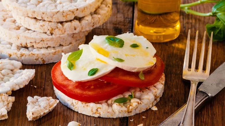 rice cake topped with tomato and mozzarella 