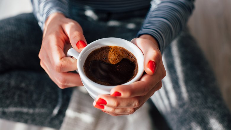 Woman holding cup of coffee