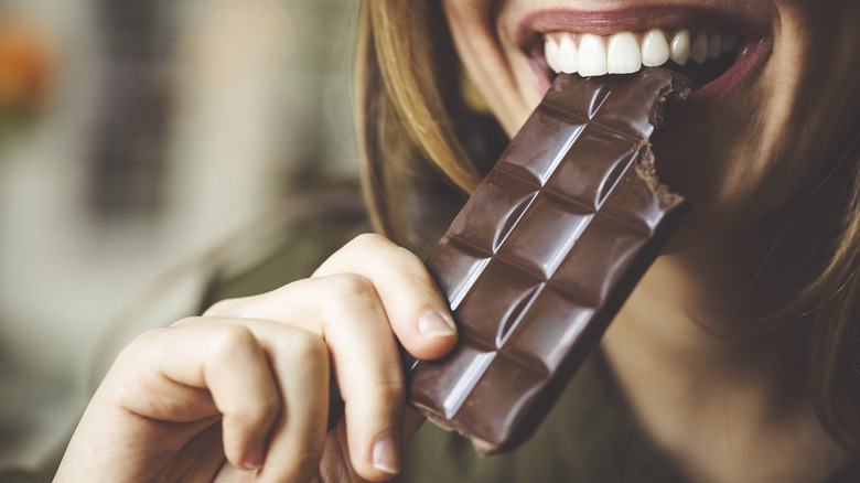woman eating chocolate bar
