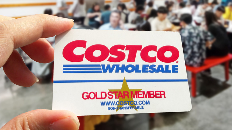 Costco membership card in hand