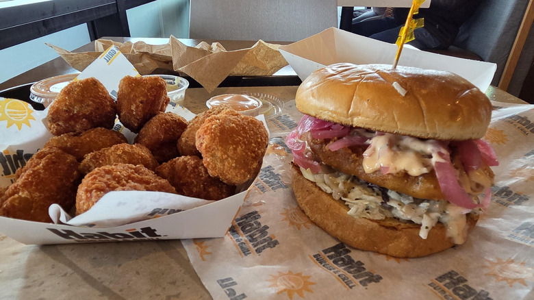 Baja Crispy Fish Sandwich beside fried corn tots