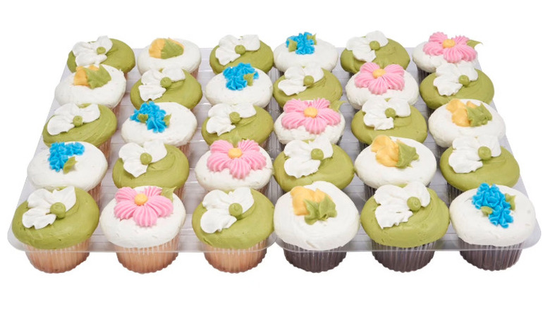 Cupcake assortment decorated for spring with 30 total cupcakes.