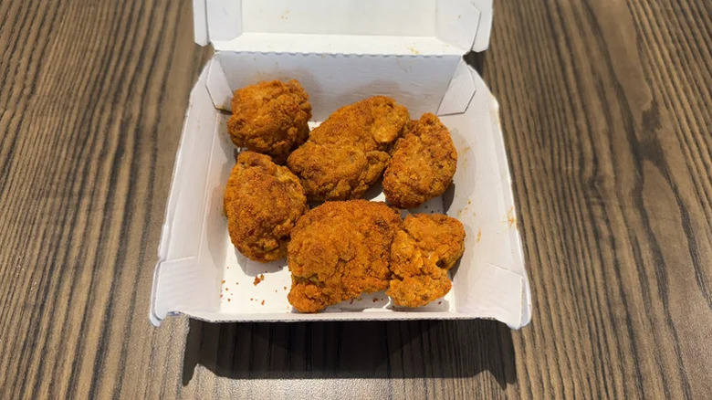 an open takeout box of Taco Bell Diablo Nuggets on table